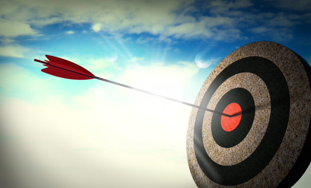 Arrow hitting the center of a target under a bright sky, symbolizing picking the right blog niche with focus and clarity.