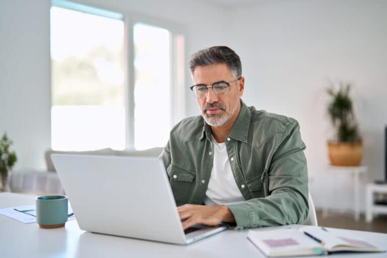 Solo content creator working on a laptop representing AI productivity tools for solo creators.