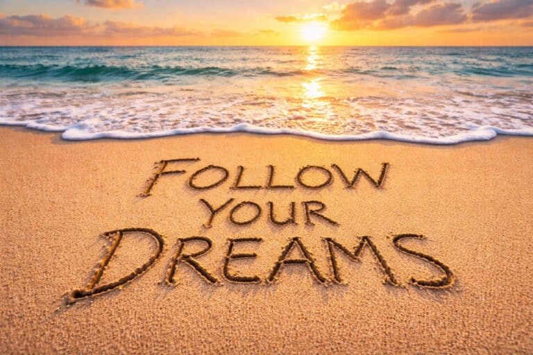 Follow Your Dreams written in beach sand with ocean waves in the background representing the journey behind danswords.com